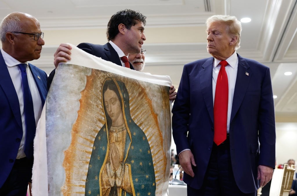Donald Trump is presented with a piece of art, 2024