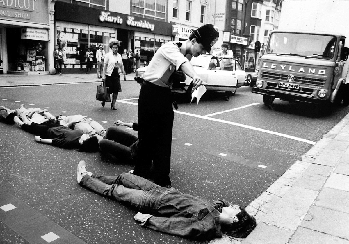 (1) Simon Dack: Activists lie in the road blockin