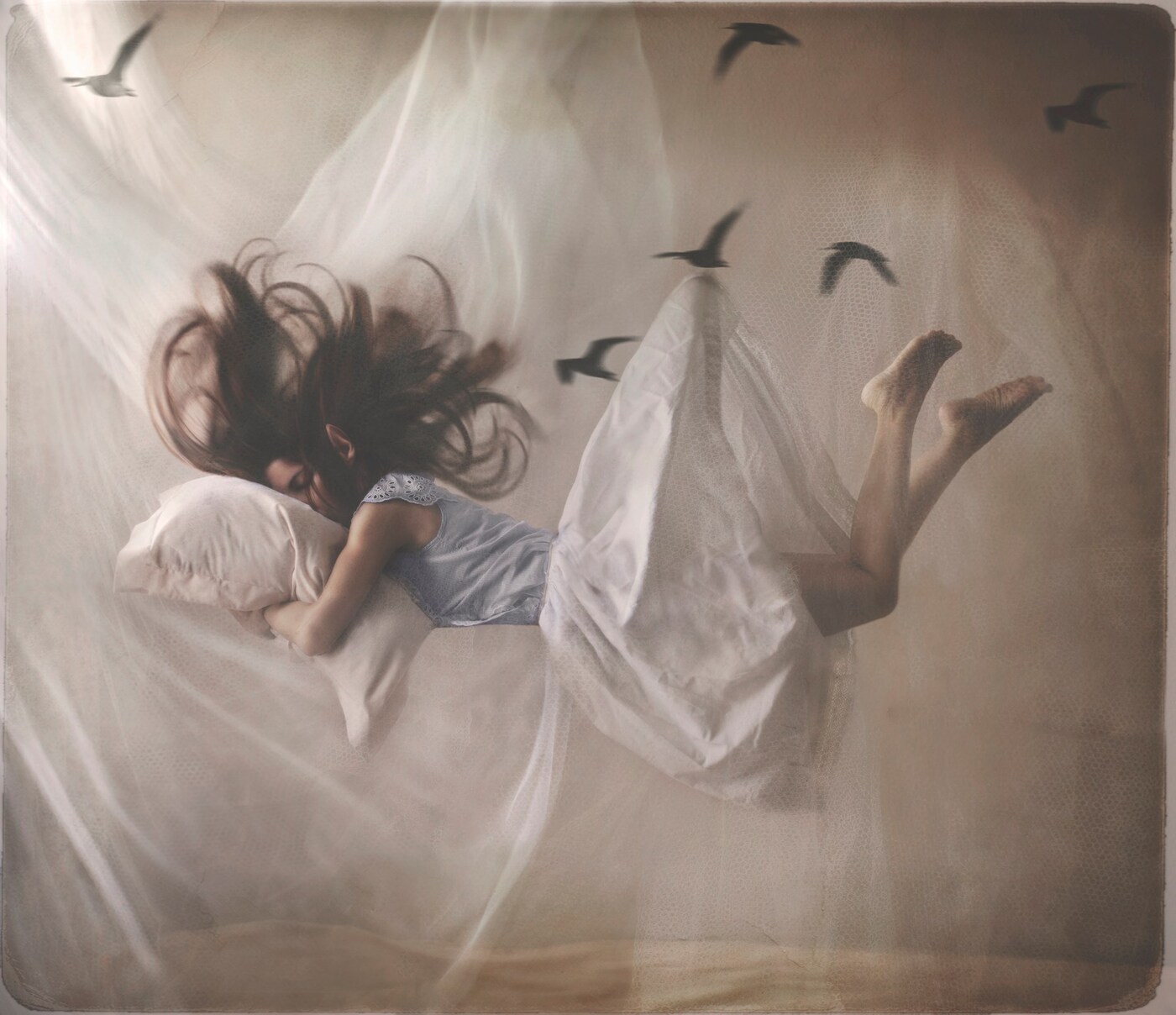 A sleeping woman floats in her room