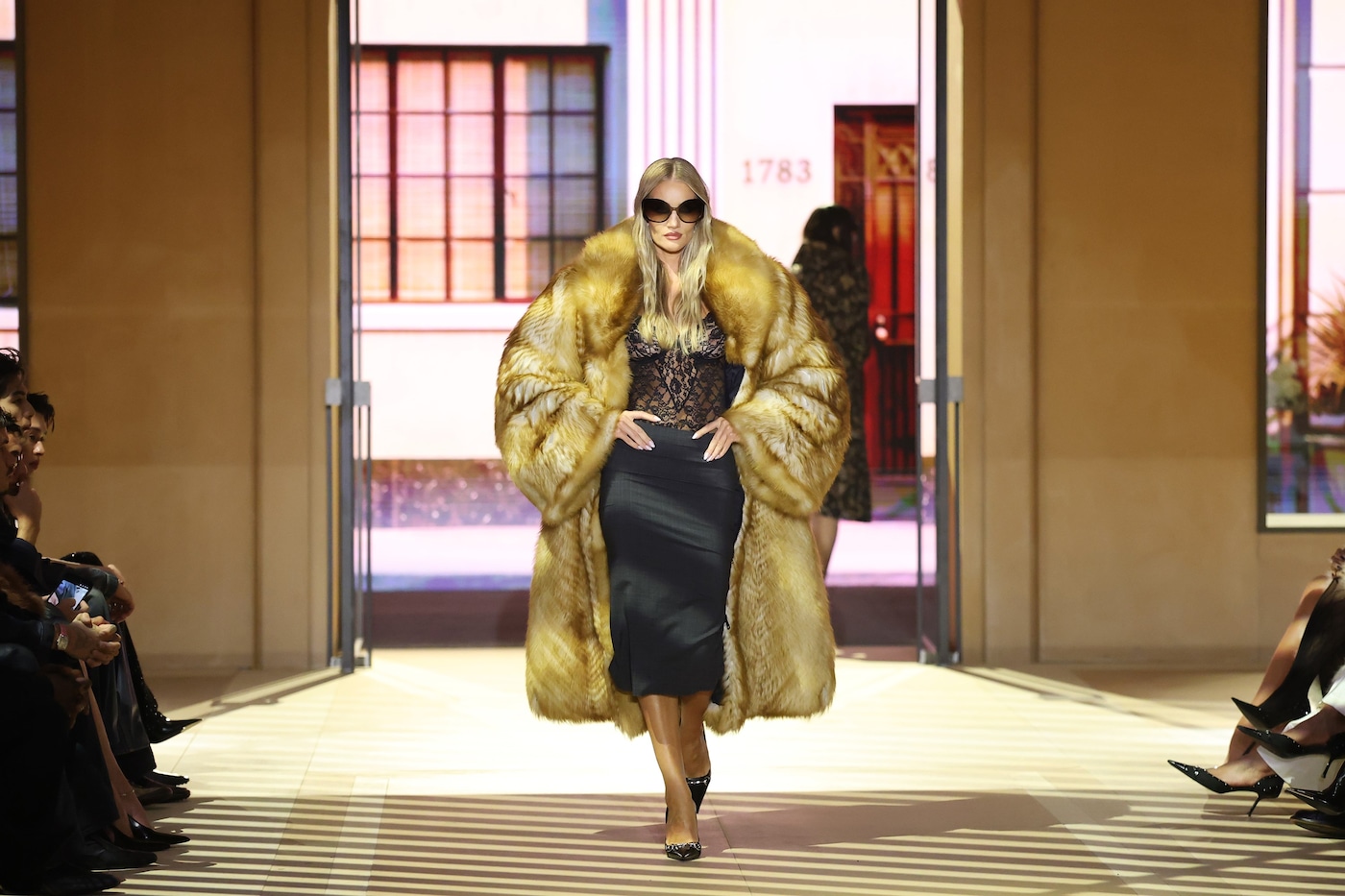 Runway look from Demna's Gucci Spring/Summer 2027 show, staged inside a mock working boutique in Milan