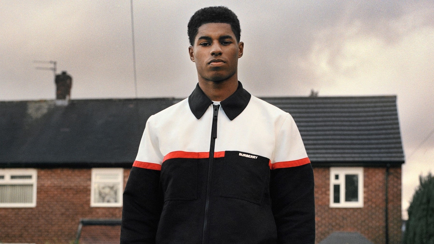 Rashford steps out in a white shirt and a beaded necklace at Paris Fashion  Week