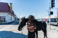 Kenneth stands on the corner with his horse 29