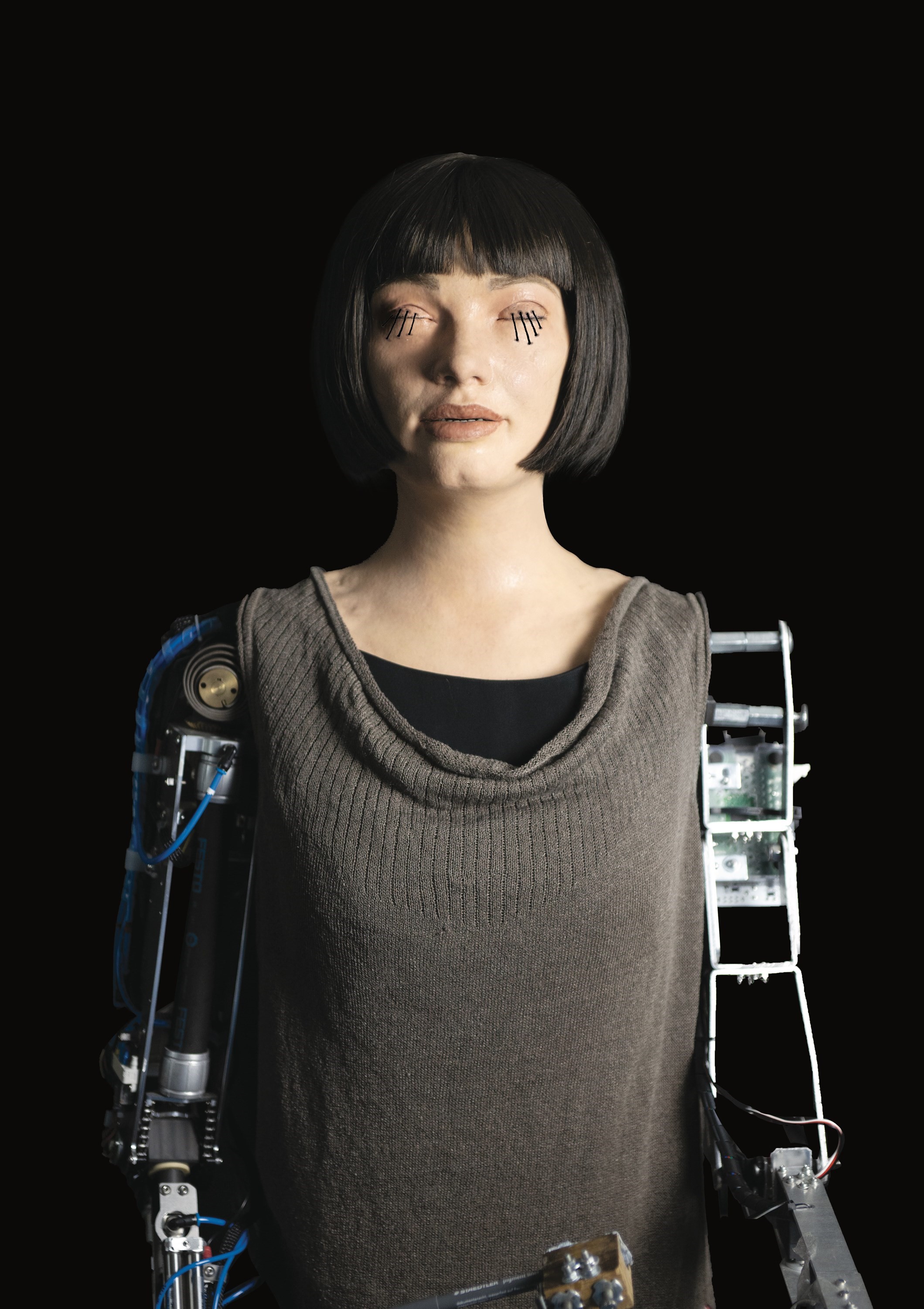 Beautiful woman and AI robot look at each other. Concept of human