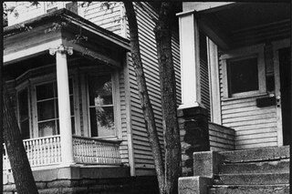 Little girl laughing while sitting on a concrete s