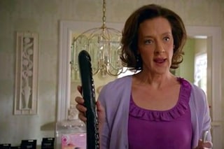 Joan Cusack holding a dildo