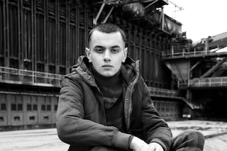  RUDI wears jacket by STONE ISLAND; jumper and tro