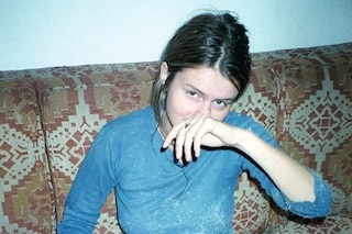 Corinne Sitting on Orange Sofa