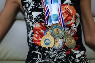 Lolita posing with her running medals