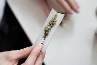 women rolling a joint weed