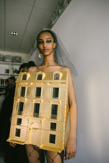 Dior just sent a wearable gold doll's house down the runway at