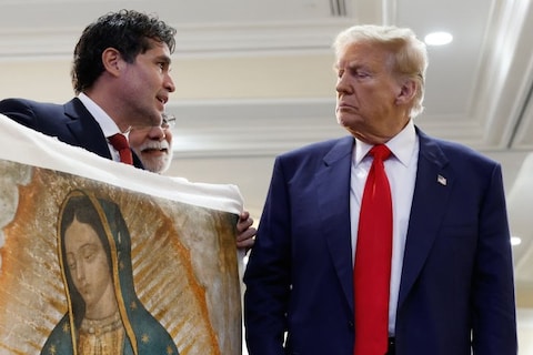 Donald Trump is presented with a piece of art, 2024