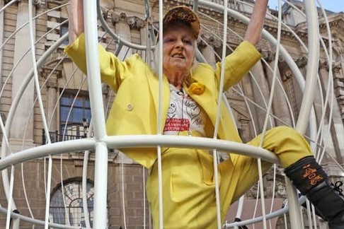 Vivienne Westwood protests in a giant cage, dressed as a canary