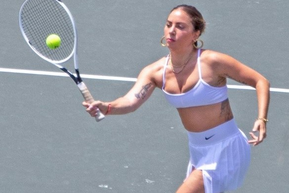 Lady Gaga serves up style wearing a white Nike sports bra and pleated skirt  for a tennis lesson