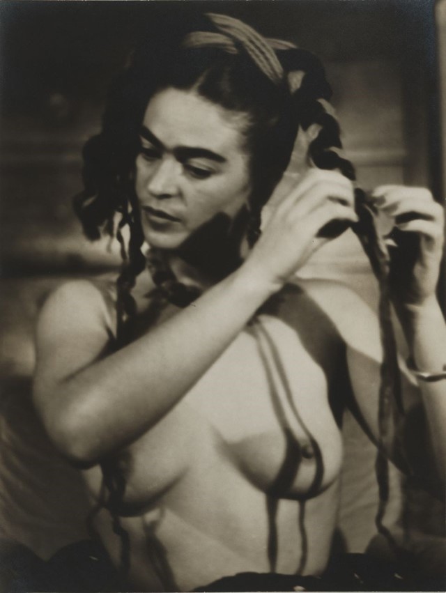 Frida Kahlo braiding her hair