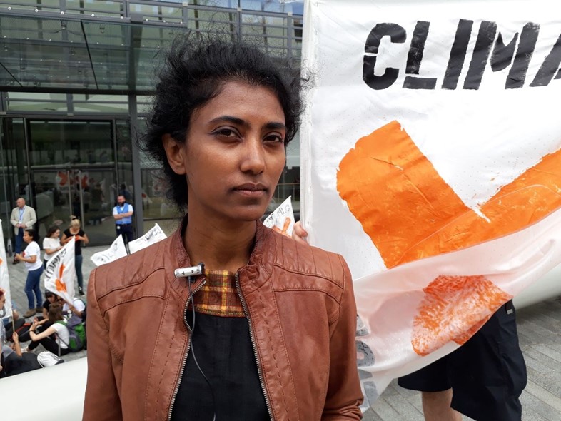 A protester outside EIB for climate action