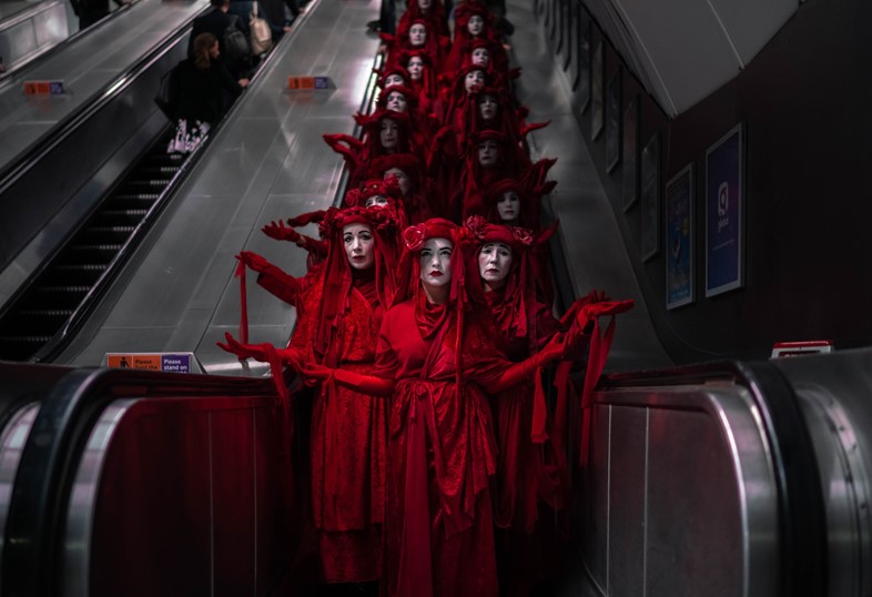 Extinction Rebellion red-robed tube protest
