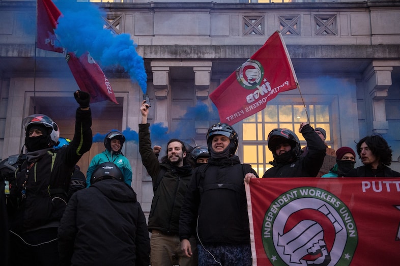 Deliveroo riders attend a protest at Hackney Town Hall 