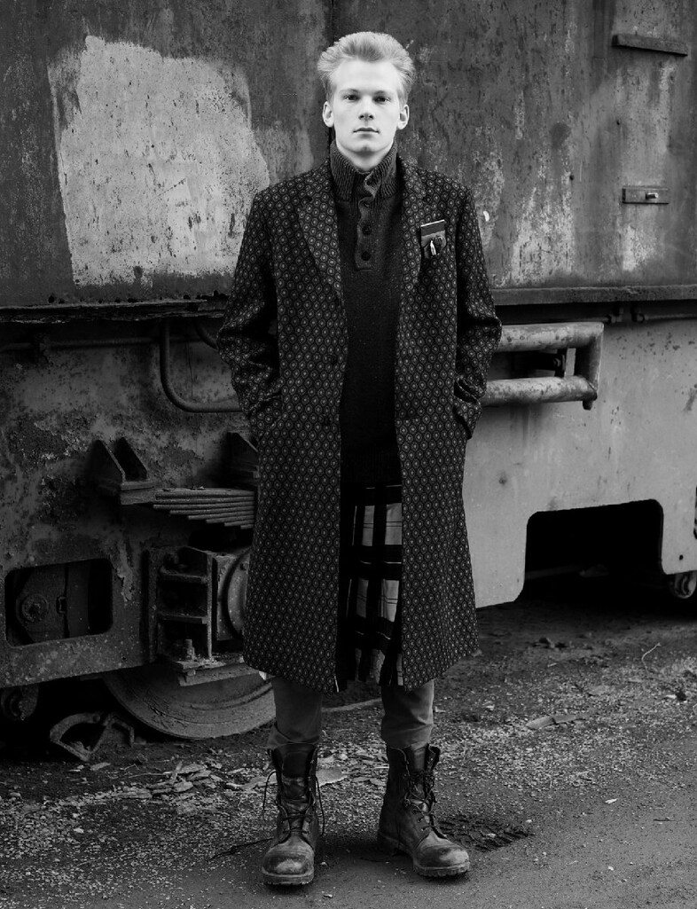 CAMILLO wears coat and pocket accessories by PRADA 1