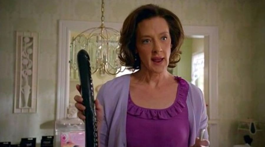 Joan Cusack holding a dildo