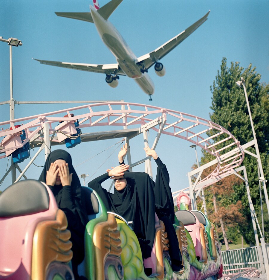 Sabiha &#199;imen, “Students riding a train at a funfair...” 0
