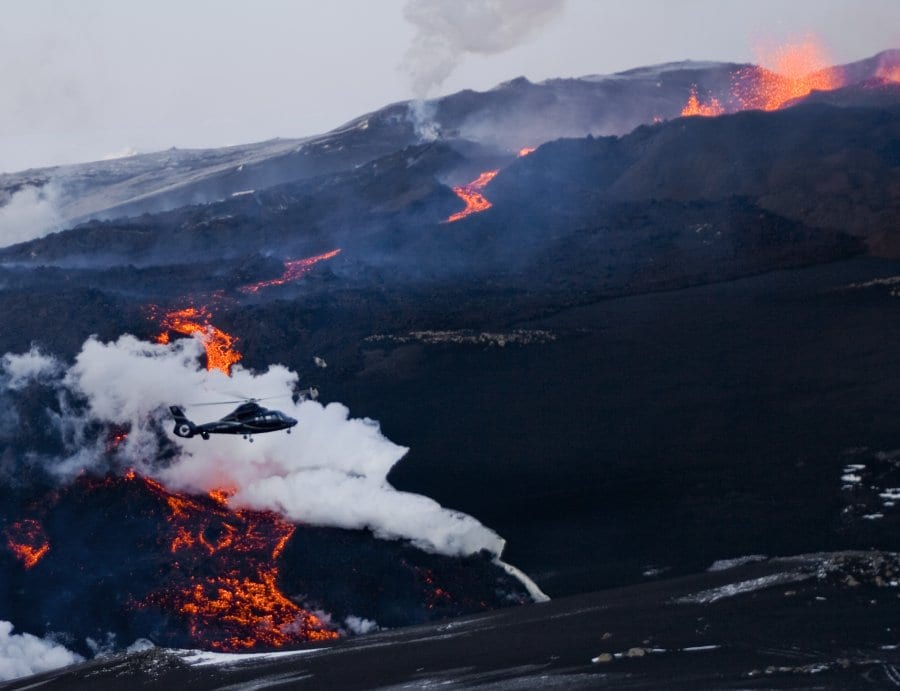 A helicopter flies above Volcano Eyjafjallajokull, 15